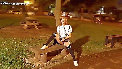 Asian chick fucks herself in public in sexy stockings