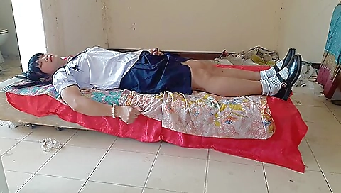 Asian teen in school uniform is wearing a sexy dress